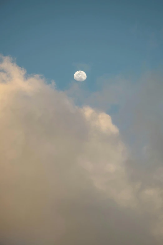 an airplane that is flying under the cloudy sky