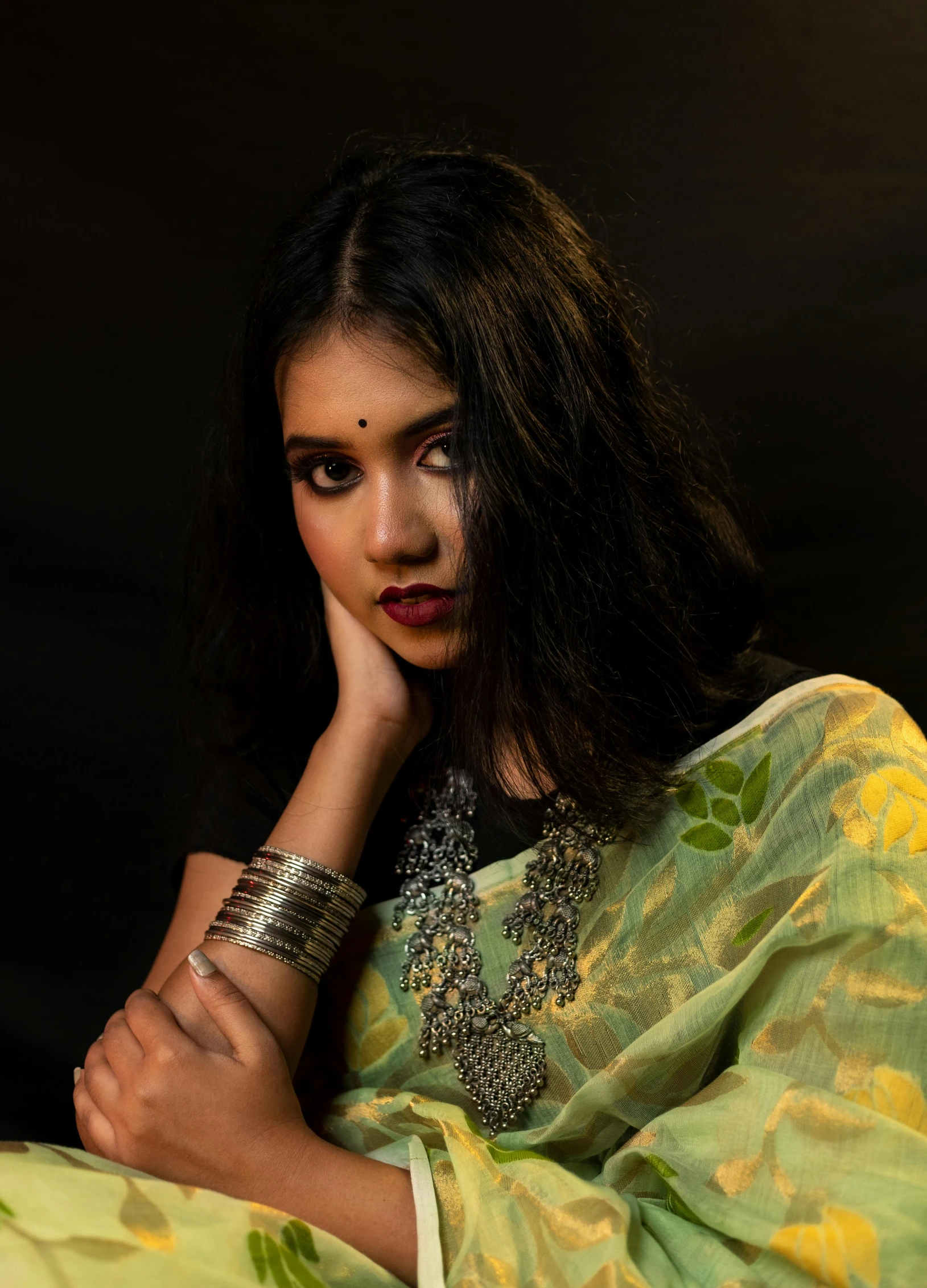 a woman wearing a sari poses for a picture