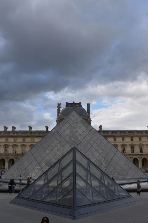 a very large pyramid shaped building in a courtyard