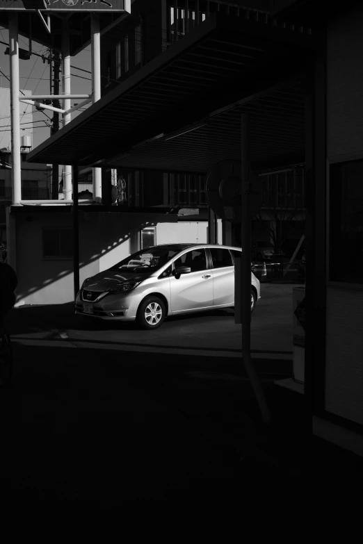 a car parked on the street next to a tall building