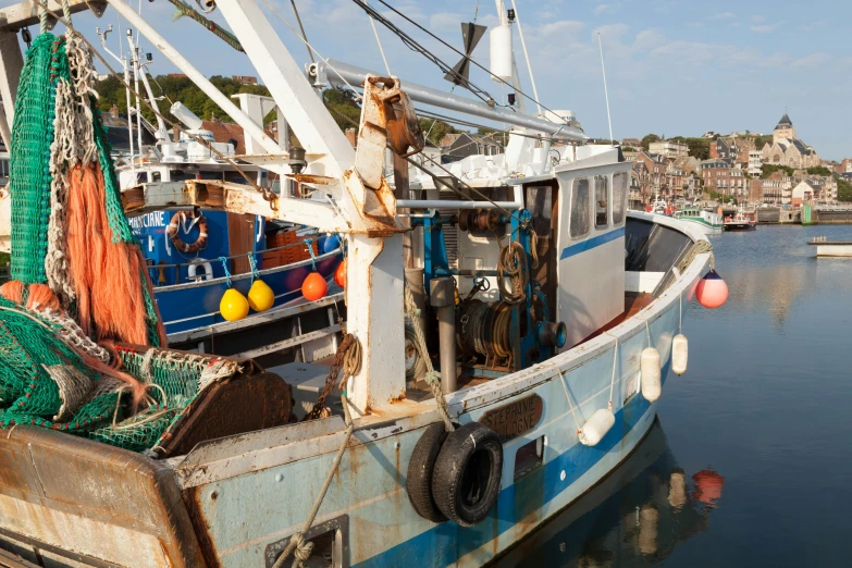 a fishing boat is parked on the beach