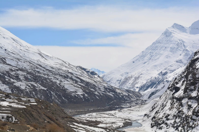 snow covered mountains, river and roads in the wilderness