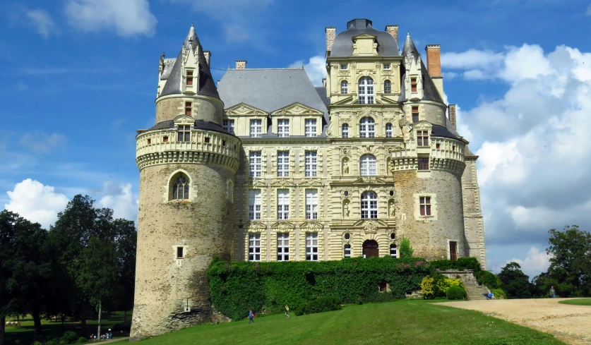 a large castle sits on a hill near some trees