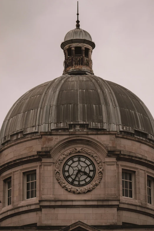 a large building that has a big clock on the side of it