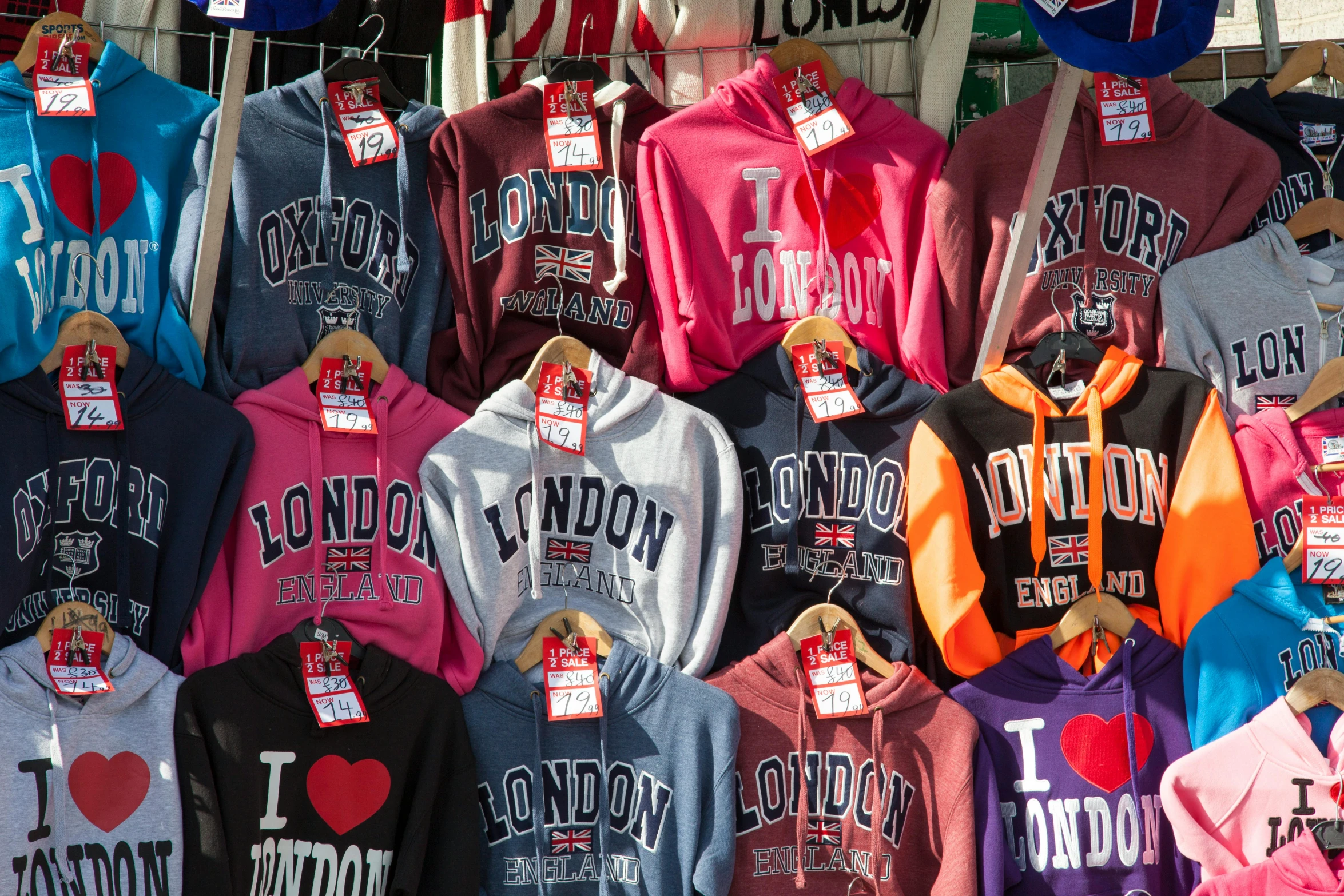 many hoodies in front of a building display