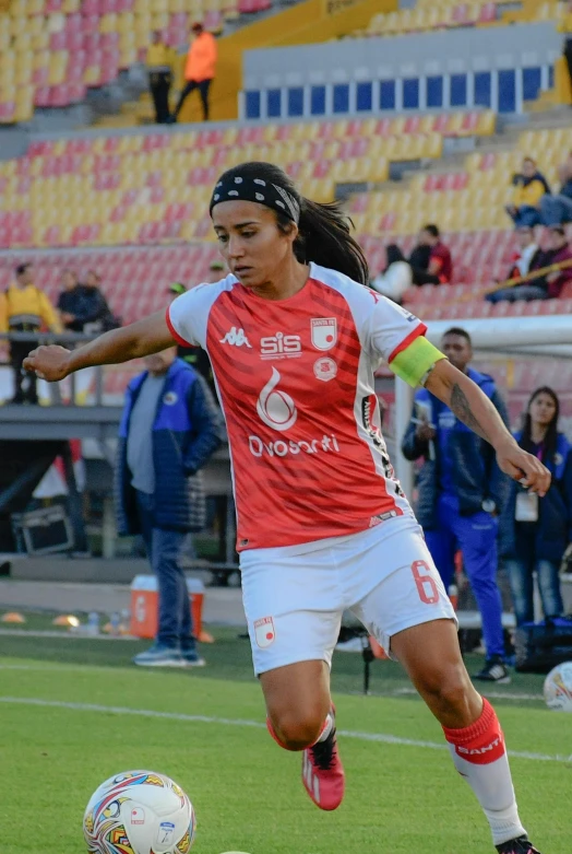 a woman playing soccer on a green field