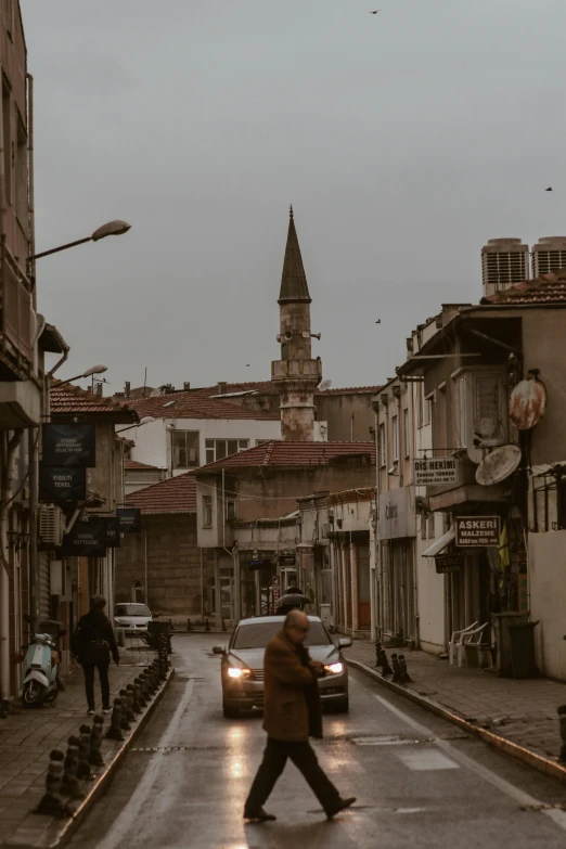 a city street with a clock tower in the distance