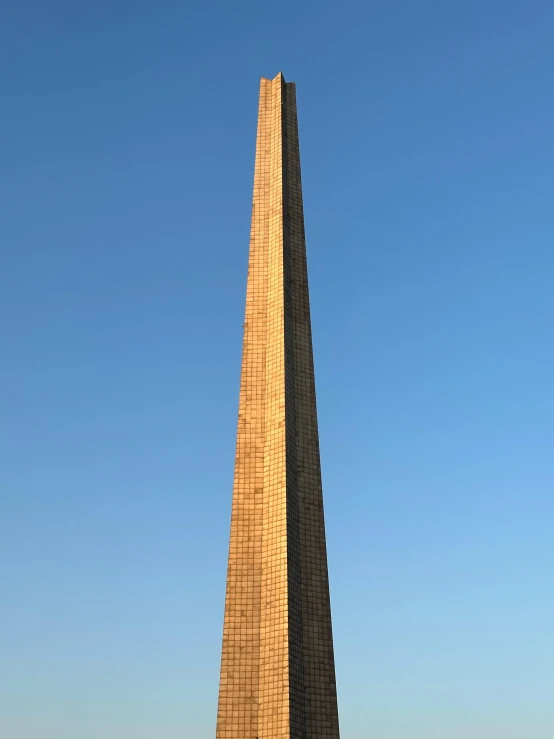 the washington monument stands in front of a clear blue sky