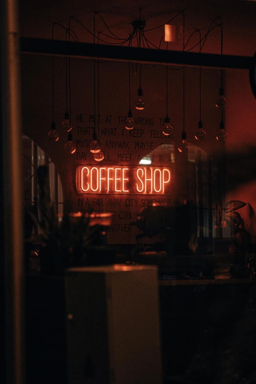 a coffee shop has the neon sign visible