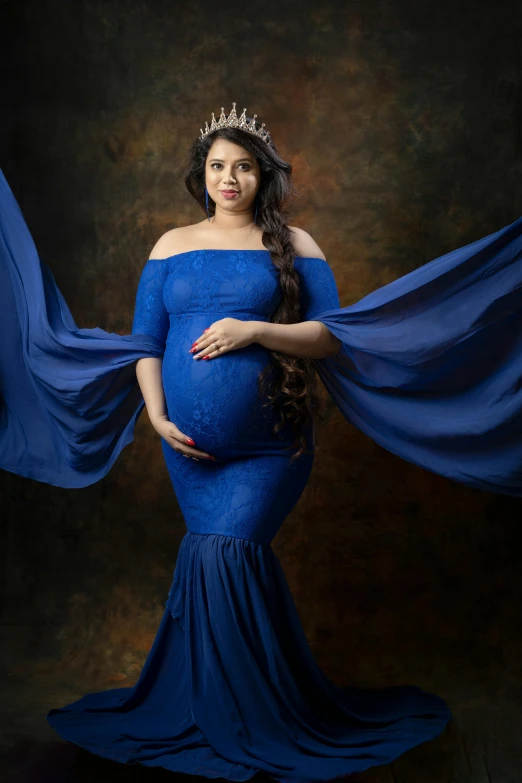 a pregnant woman in a blue dress