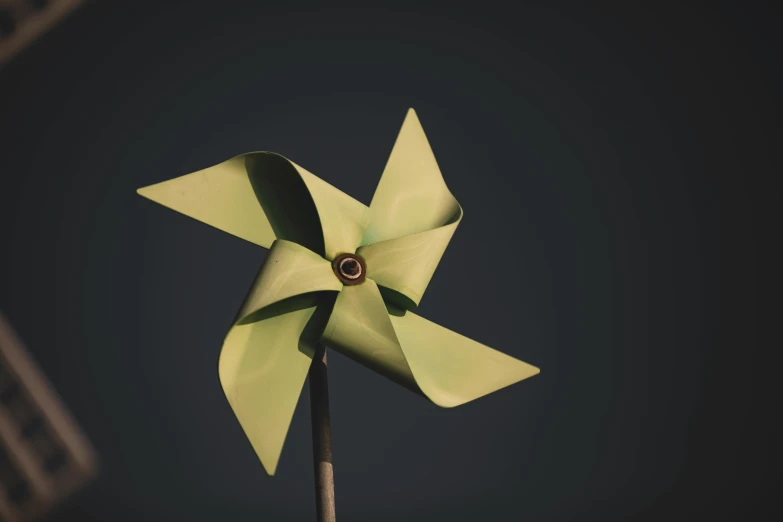 a green pinwheel with one green flower