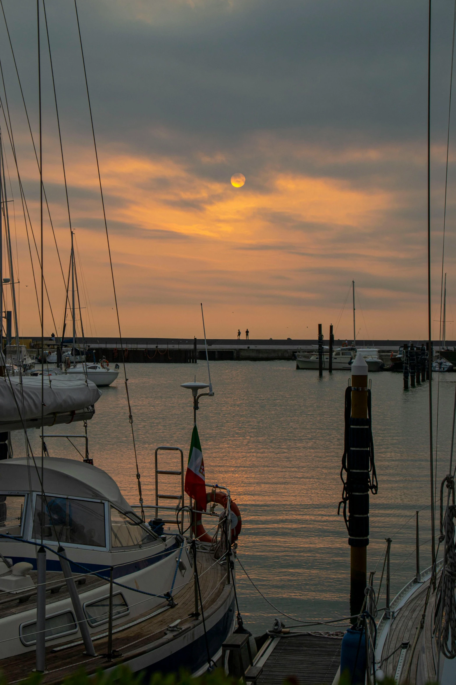 the setting sun over a calm bay in the evening