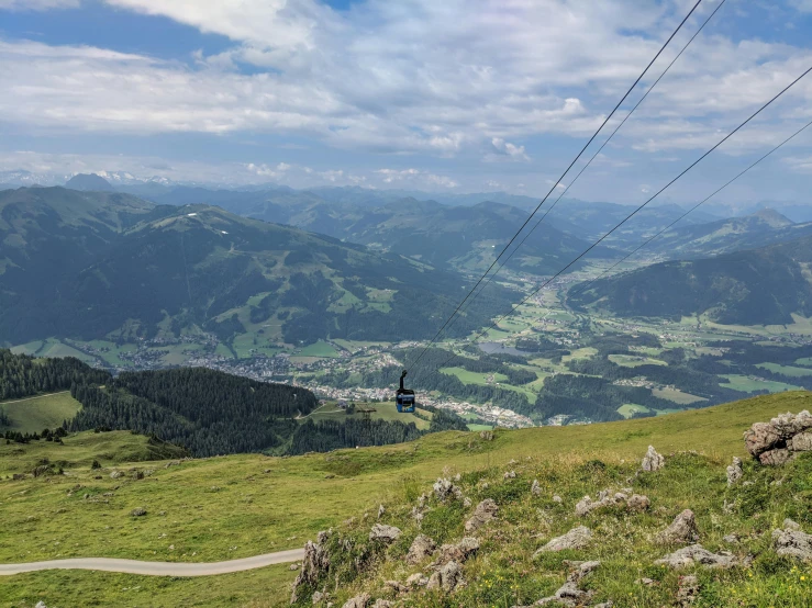 a person on a mountain with mountains in the background