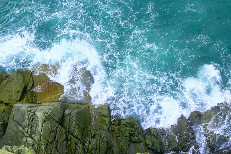 the water is choppy and breaking over rocks