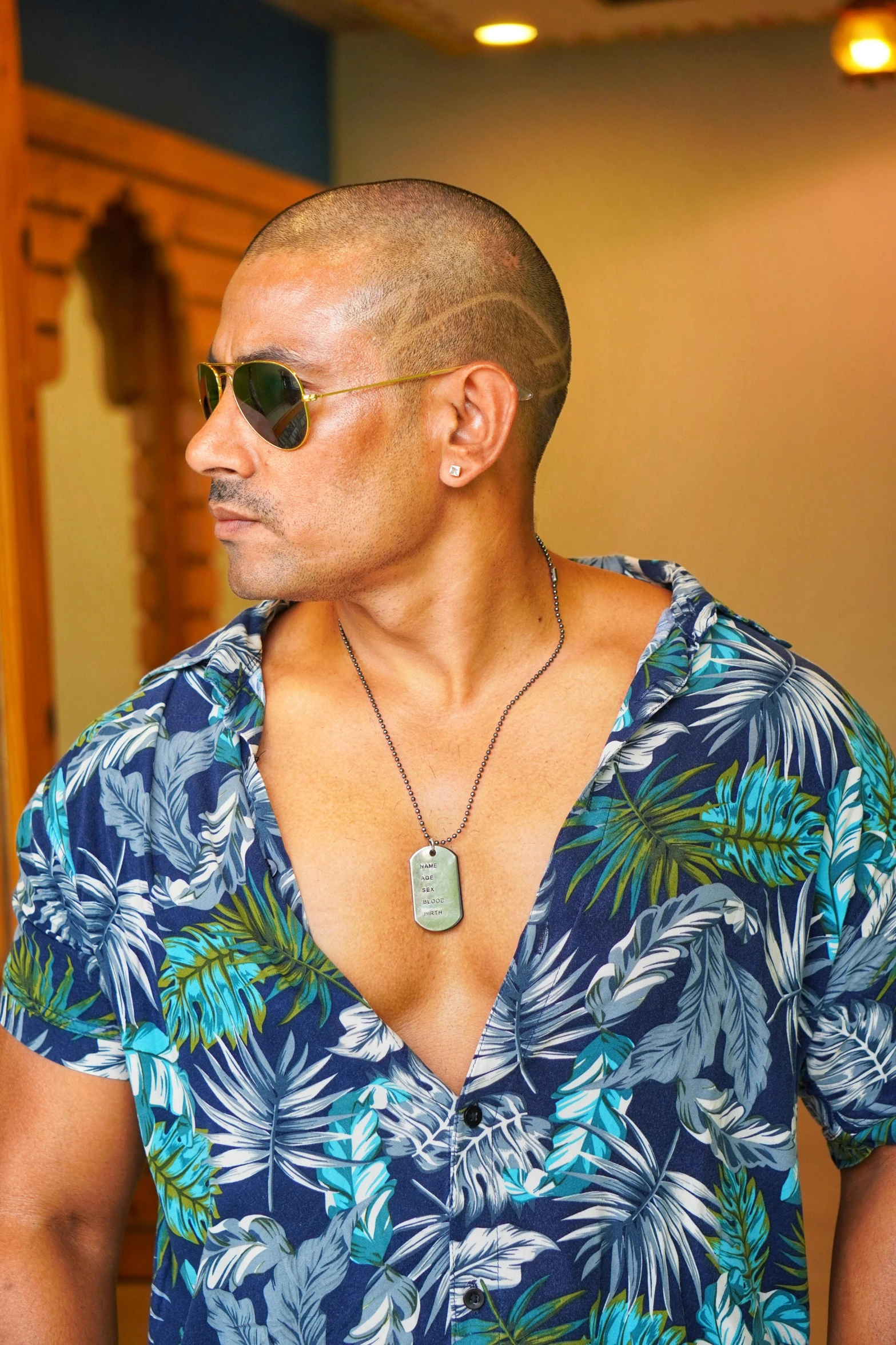 a man with a blue shirt on wearing sunglasses
