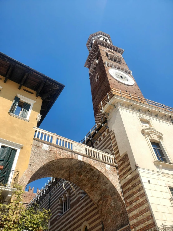 an archway between two buildings with a clock