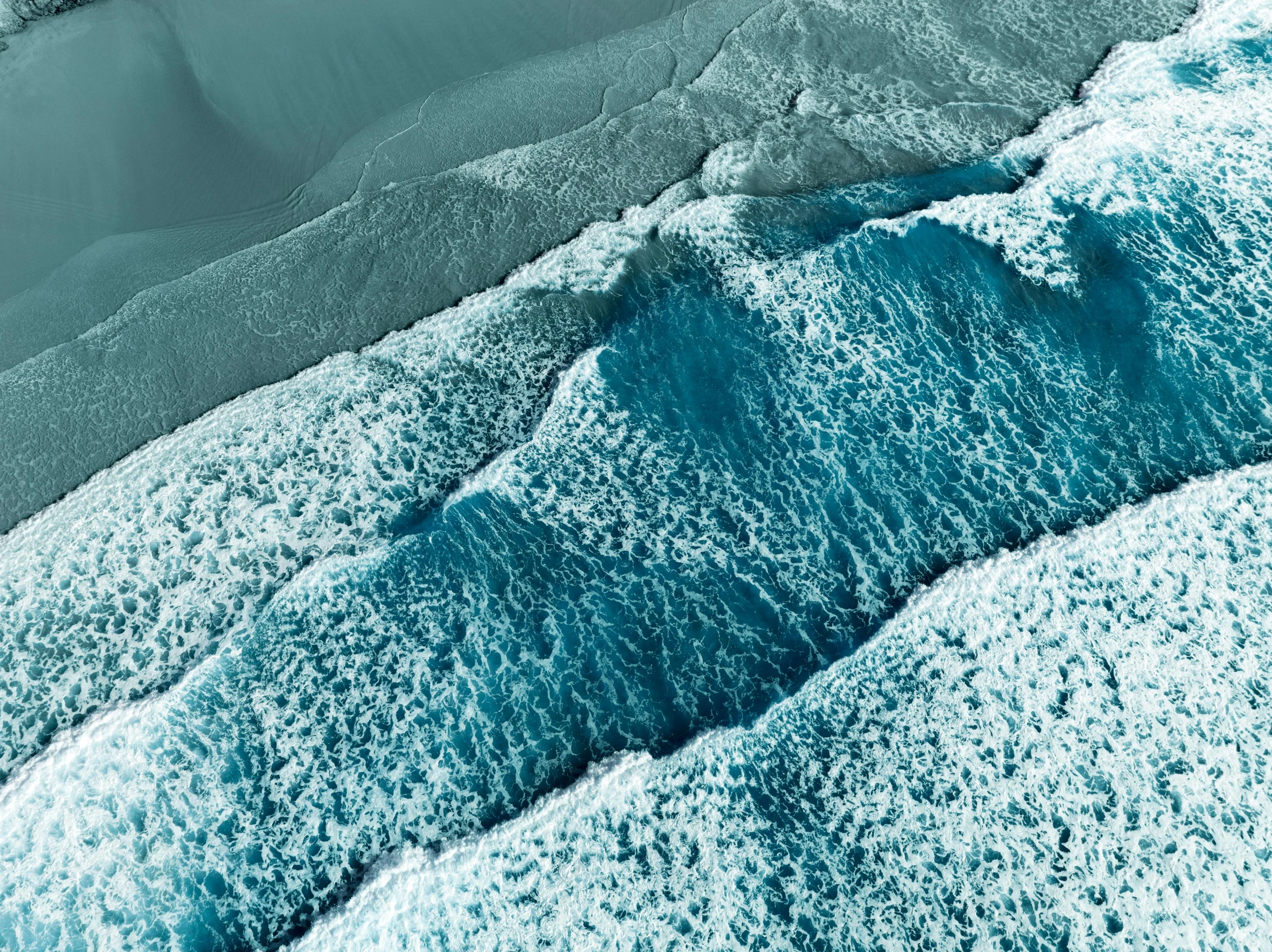 a view of a water with ice and waves