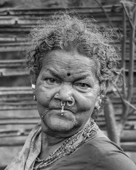 an old woman with a nose ring in a black and white po