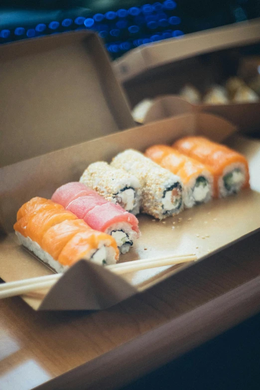 a few sushi rolls sitting on a  board