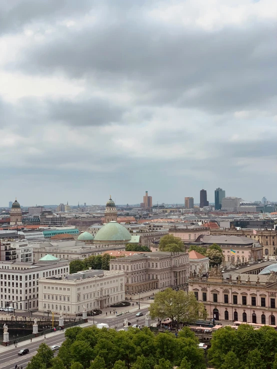 a city view with lots of buildings under cloudy skies