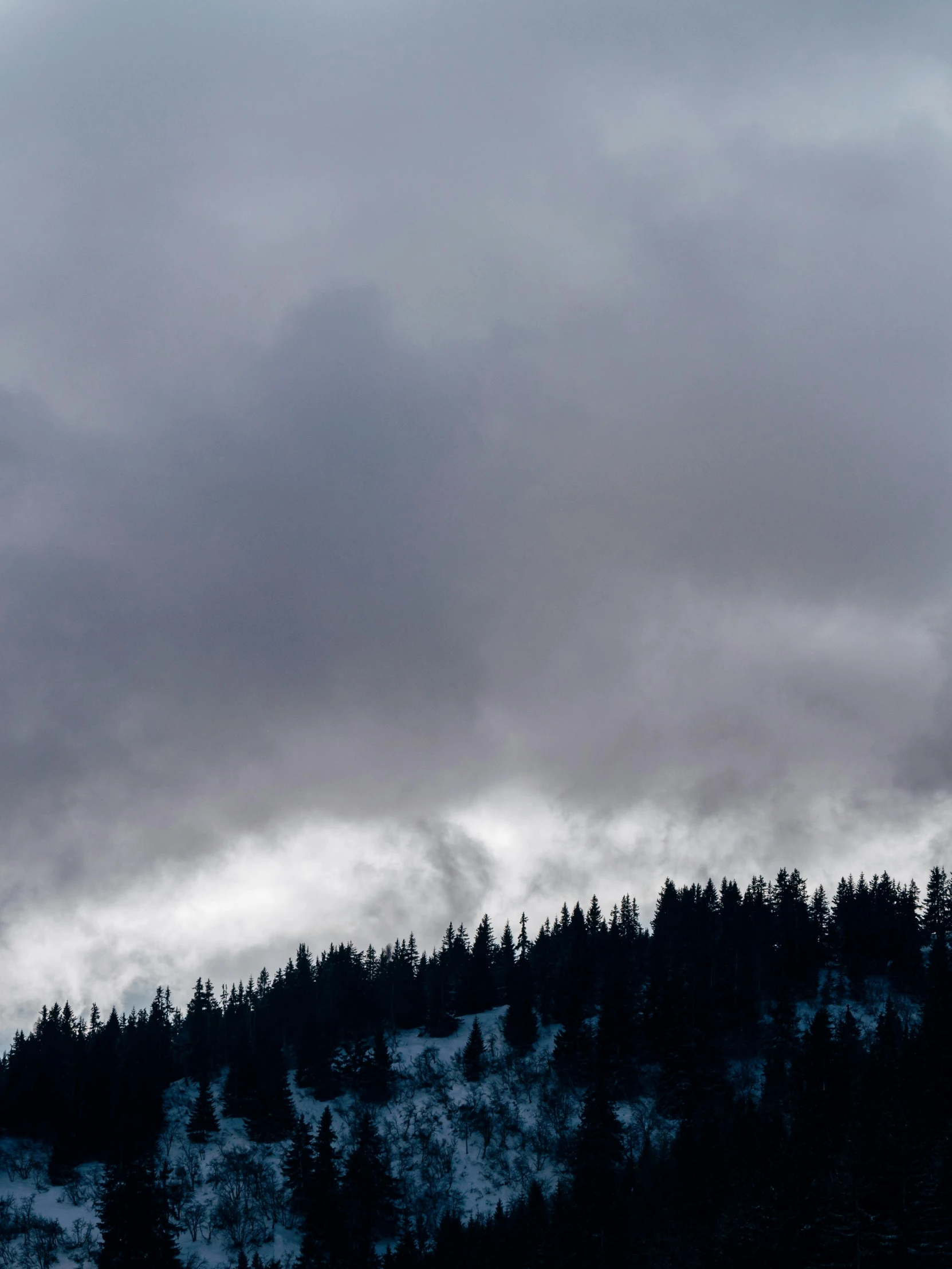 an airplane is flying over the top of a hill