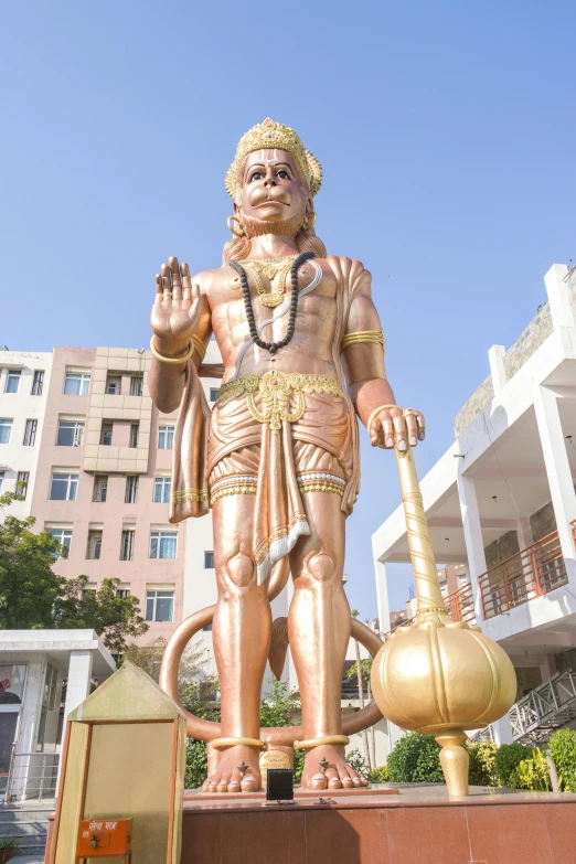 the large golden buddha statue has an ornamental pot in front