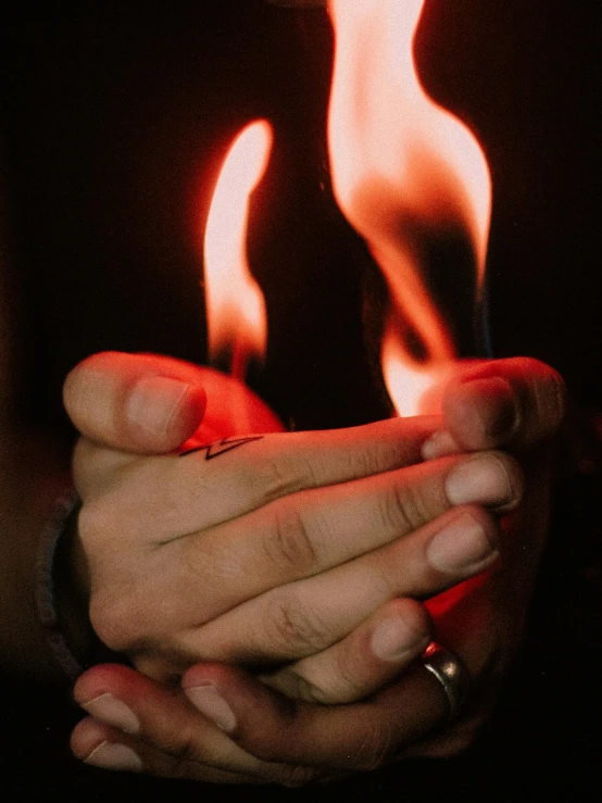 a man that is holding some kind of cigarette