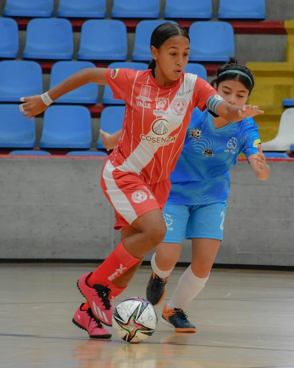 a couple of women playing a game of soccer