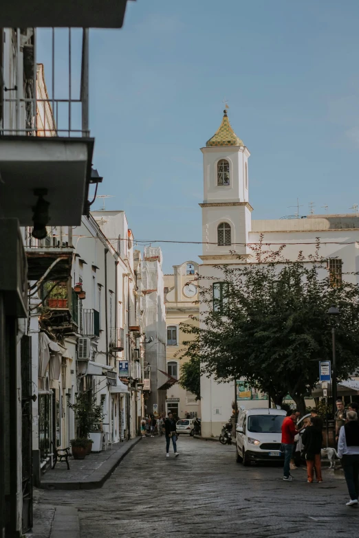 a couple of people walk down a busy street