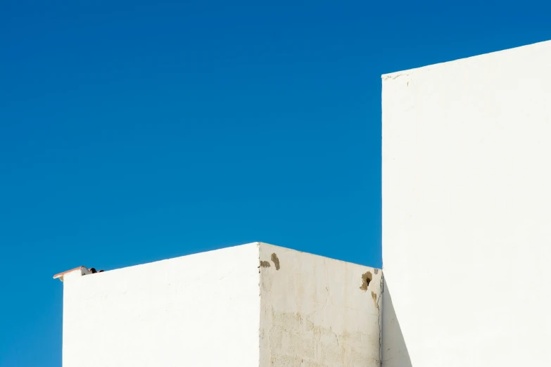 two buildings against the blue sky on a sunny day