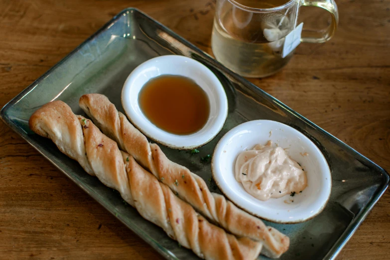 a meal consisting of garlic sticks, bread and mayonnaise