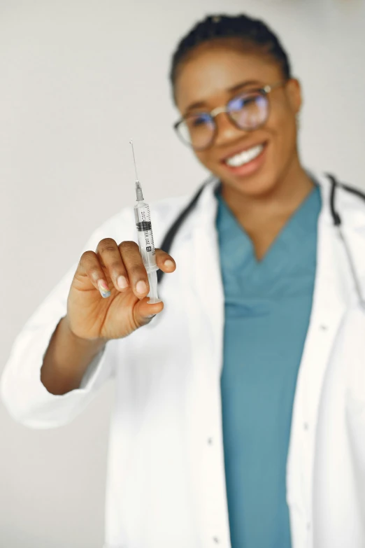 a woman in white coat holding up a sys