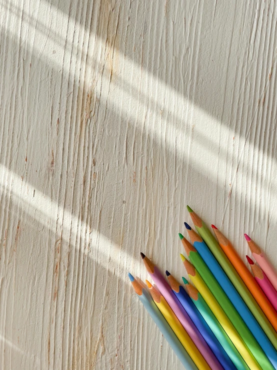 an assortment of colorful pencils next to one another