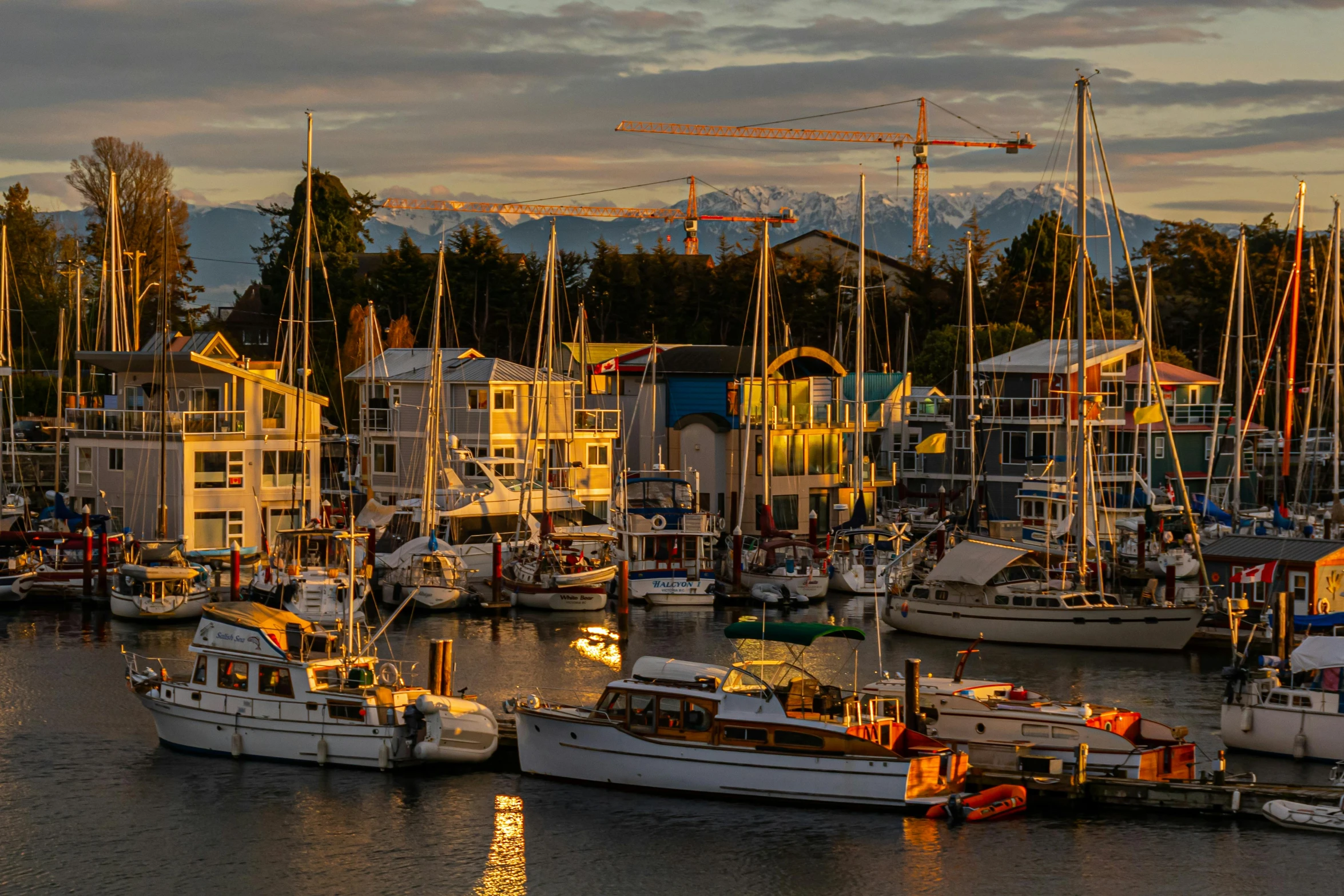 many large boats floating on the water and some buildings