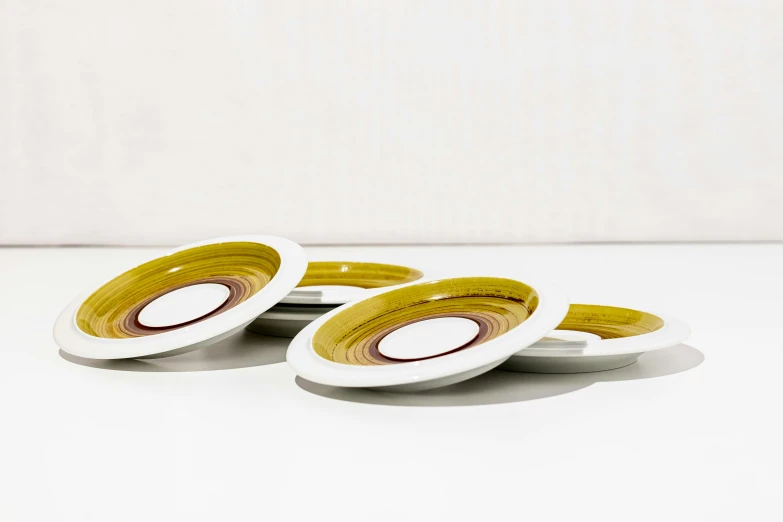 four small bowls on a white table