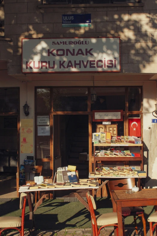 a food stand with chairs and tables outside of it