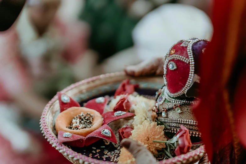 the bowl is holding several colorful pieces of accessories