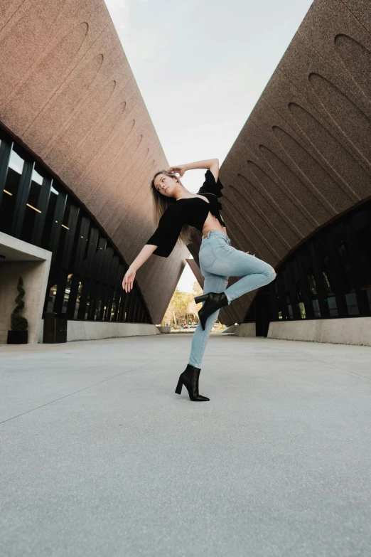 the girl is playing with her foot as she dances