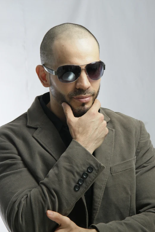 a bald man wearing sunglasses posing for a picture