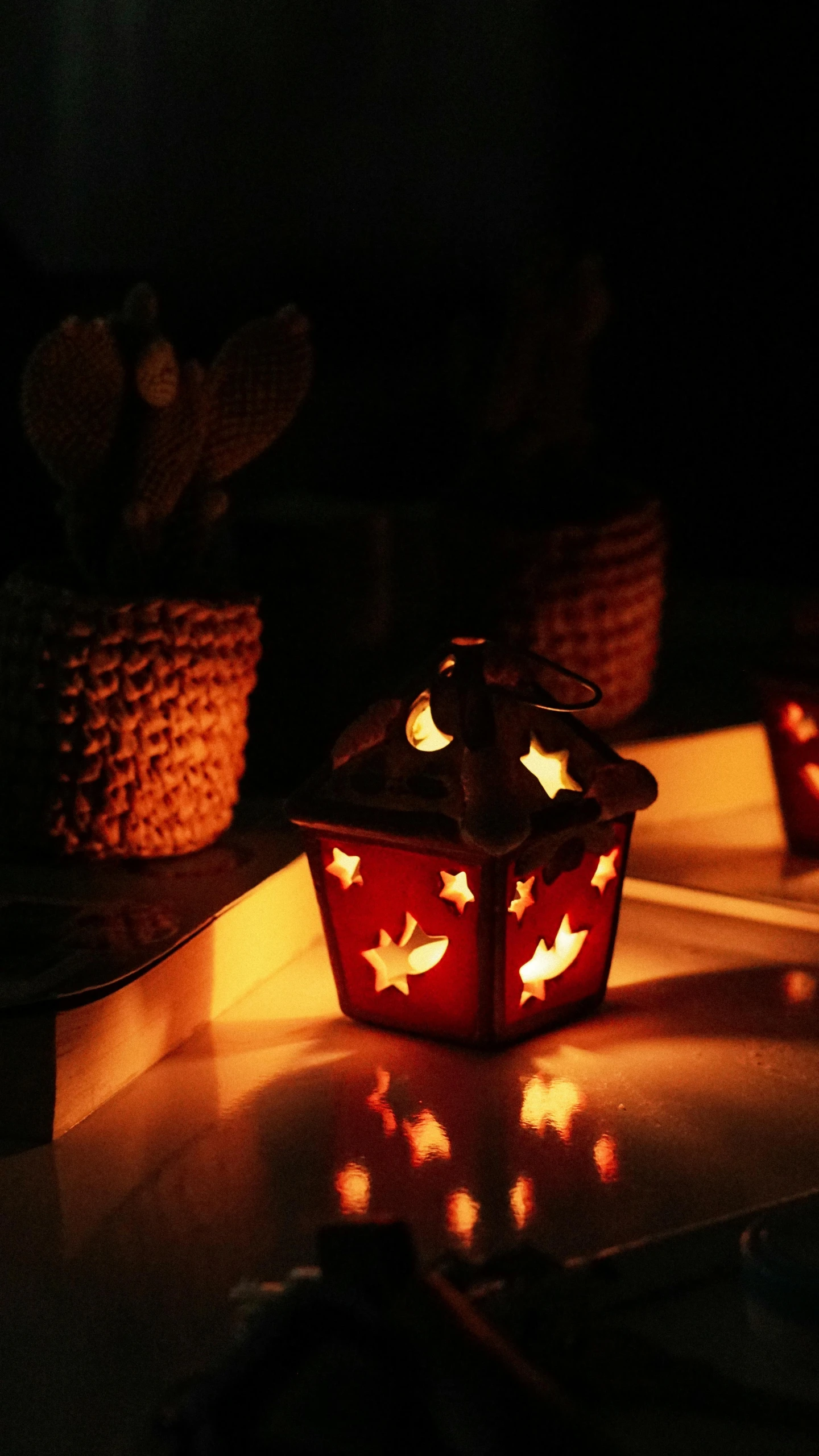 a lighted object is next to some pots