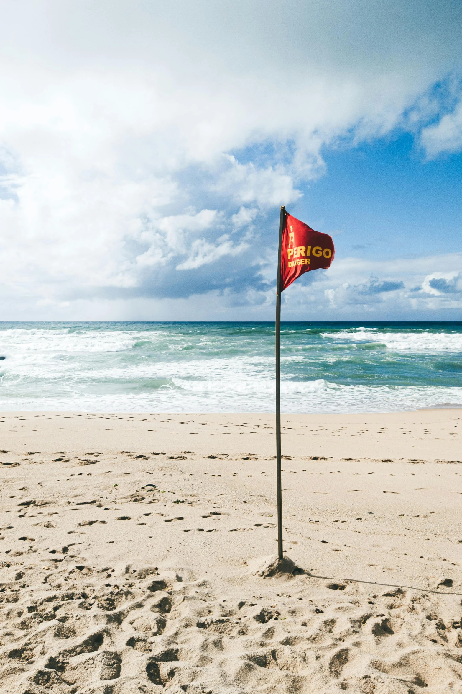 a beach with a very large flag in the sand