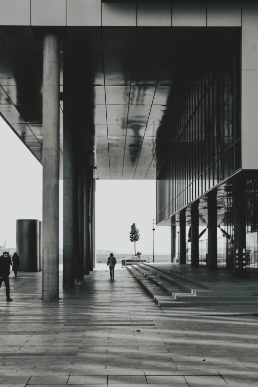 a couple walking under an overhang in an empty building