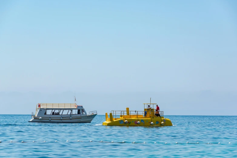 there are two yellow boats in the blue water