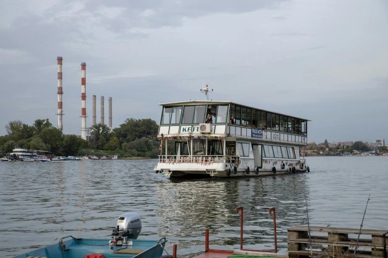 a boat traveling down the water near power stations