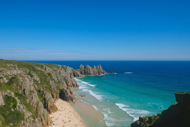 an ocean beach with clear blue water on a sunny day