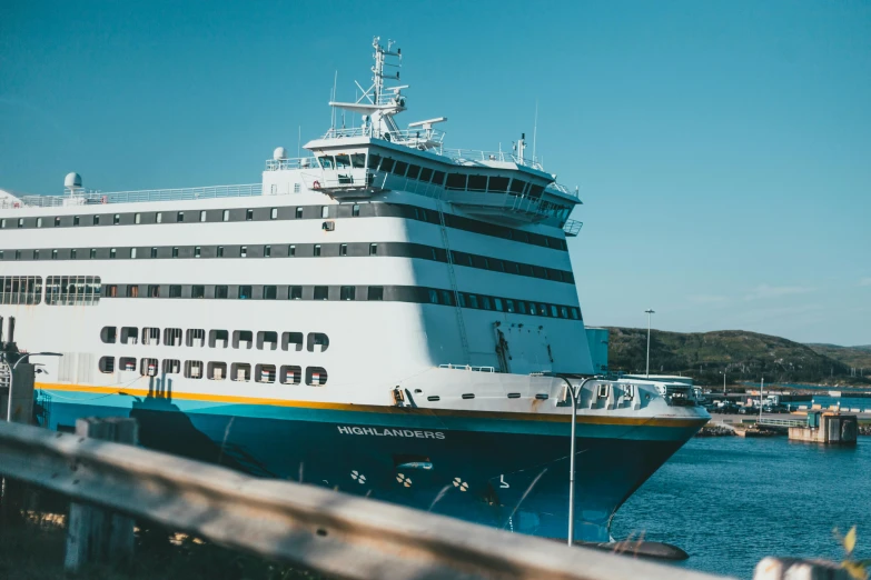 a boat sitting at a dock with other boats near by