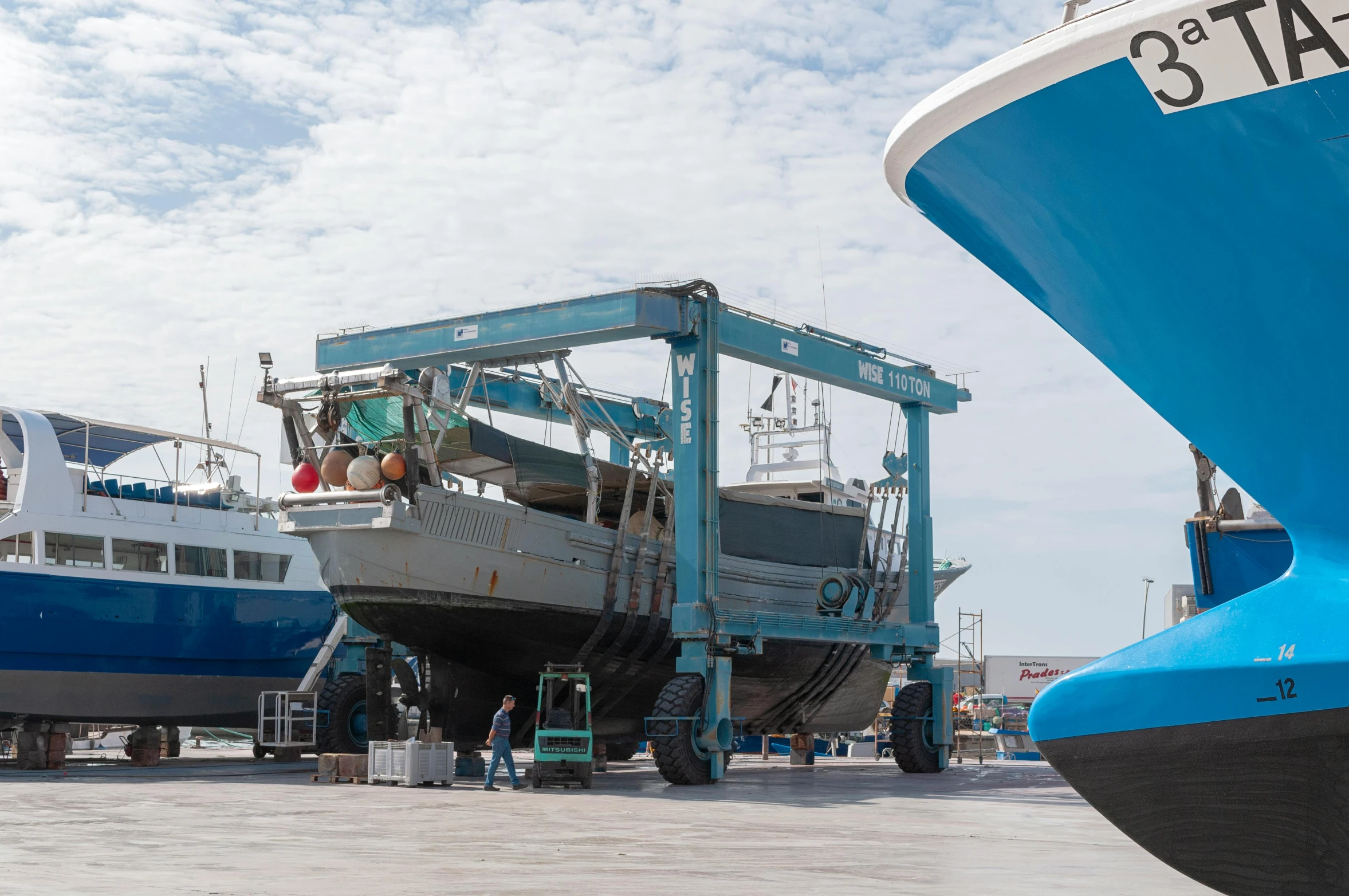 a blue and white ship under construction at a dock