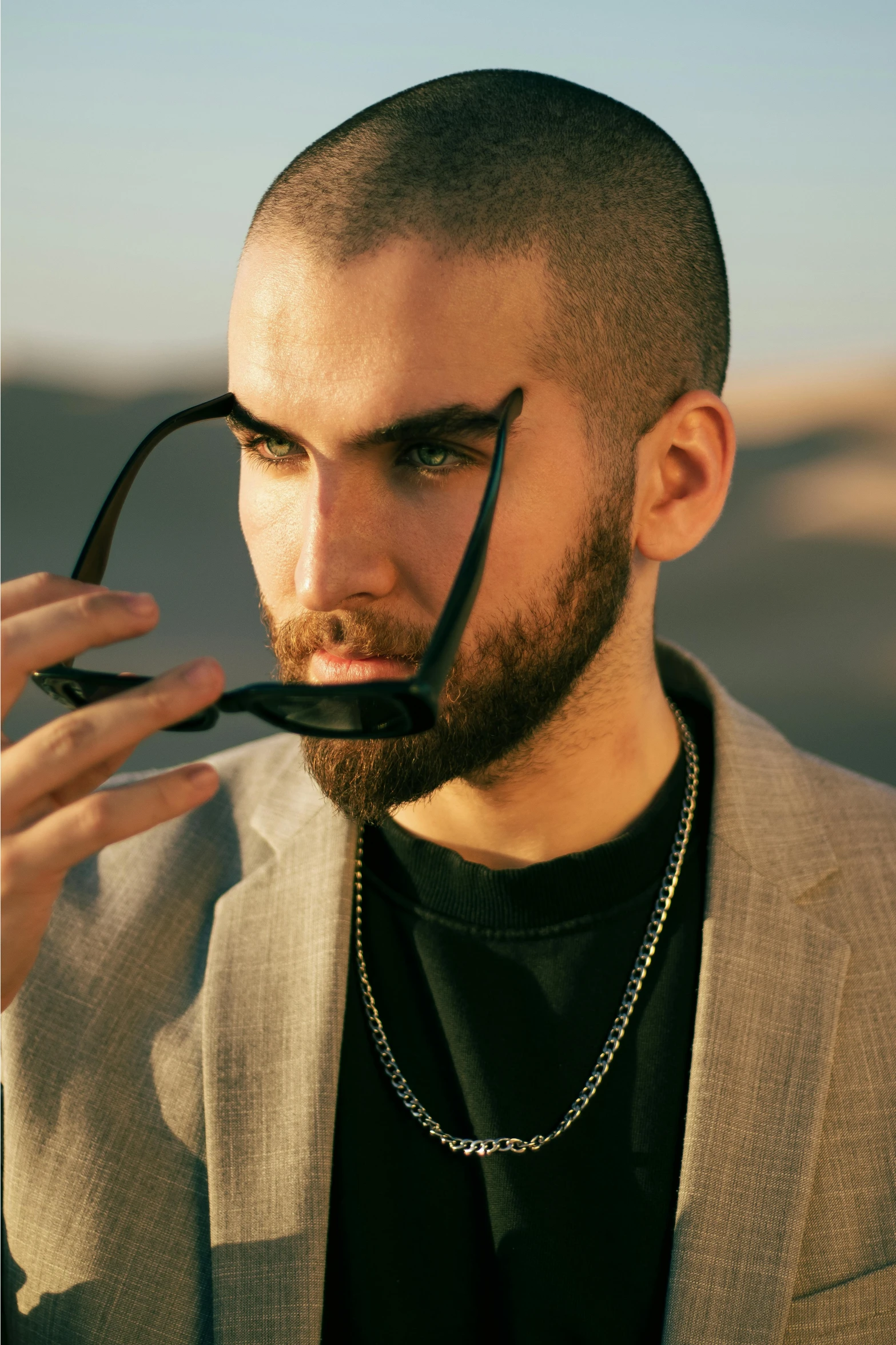 a young man in a suit with an unusual nose piece