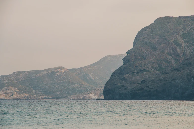 a mountain in the distance is reflected on the water