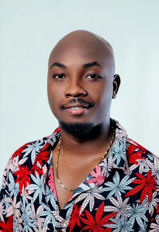 a man with a tie and flower shirt on